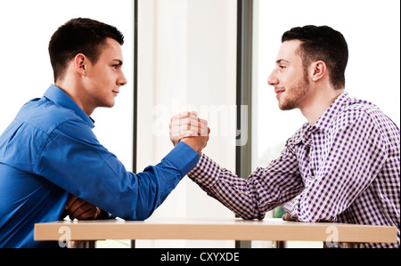 Two colleagues participating in an arm wrestling Stock Photo