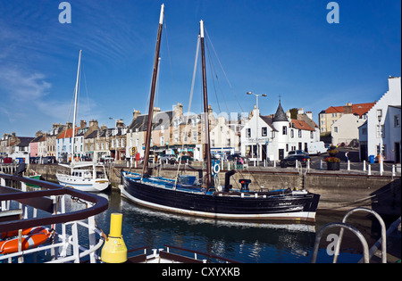 Anstruther Harbour in Fife Scotland with Fifie type fishing vessel Reaper moored near the Scottish Fisheries Museum Stock Photo