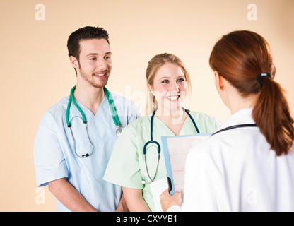 Doctor having a discussion with her caregivers Stock Photo