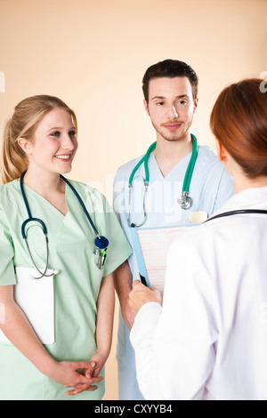 Doctor having a discussion with her caregivers Stock Photo