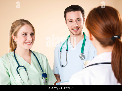 Doctor having a discussion with her caregivers Stock Photo