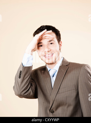 Young businessman looking into the distance Stock Photo