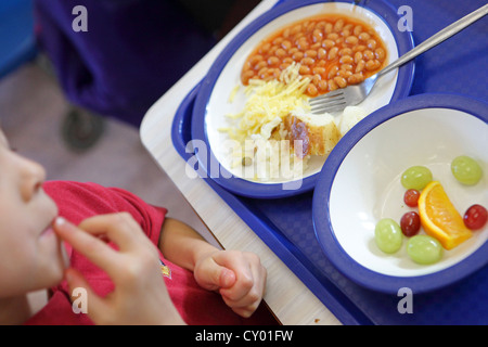 healthy school dinners served in London Primary School. Hot healthy food prepared in school kitchen. Stock Photo