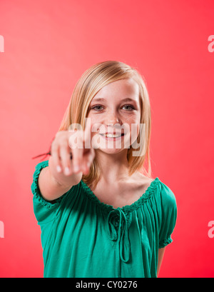 Teen caucasian girl pointing towards you Stock Photo - Alamy