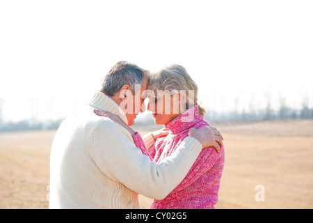 Senior couple hugging with their eyes closed Stock Photo