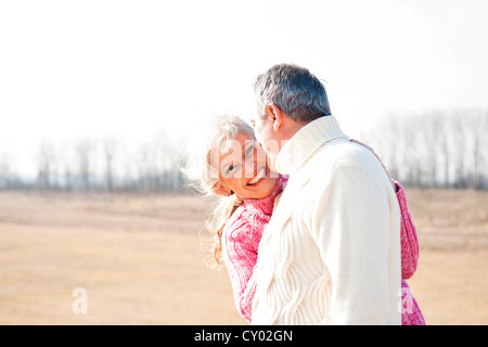 Smiling woman hugging her partner Stock Photo