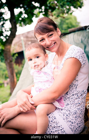 Mother and her little daughter, outdoors portrait Stock Photo
