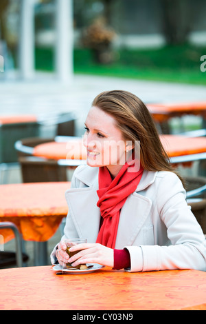 Young woman in an outdoor cafe Stock Photo