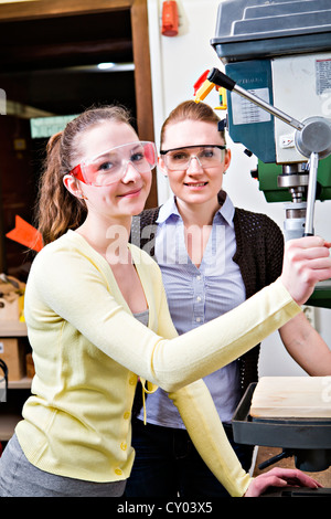 Young female teacher and a teenage schoolgirl in the handwork classroom Stock Photo