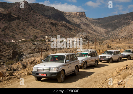 Convoy of four wheel drive vehicles with tourists on an excursion into the Jabel Shams Mountains, Sultanate of Oman, Middle East Stock Photo