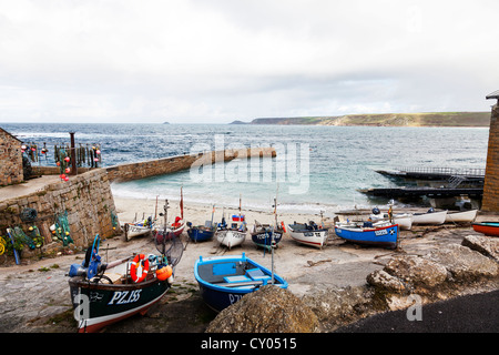 Fishing boats on dry land in Sennen Cove, Cornwall, moored up in harbour harbor Stock Photo
