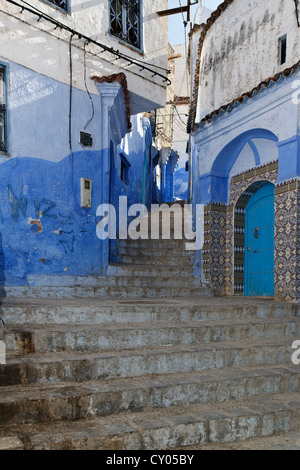 Narrow alleyway with steps and blue-washed houses in the old town of Chefchaouen or Chaouen, Tanger-Tétouan, Morocco, Maghreb Stock Photo