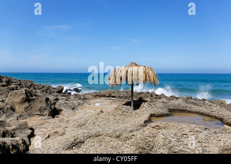 Parasol made of straw on the coast of the Atlantic Ocean, Tangier-Assilah, Tangier-Tetouan, Morocco, North Africa, Maghreb Stock Photo