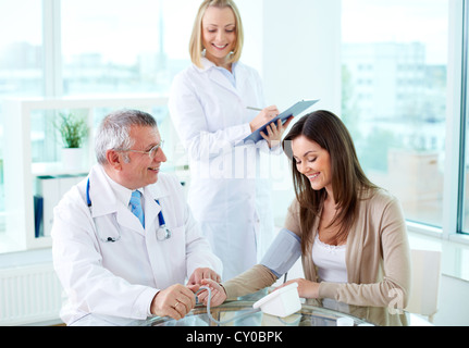 Portrait of male practitioner measuring blood pressure in hospital Stock Photo