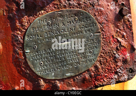 Charity collection plate on old sea mine. Stock Photo