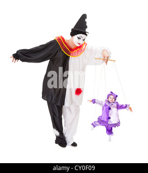 Pierrot playing with a living clown as a marionette puppet on strings Stock Photo