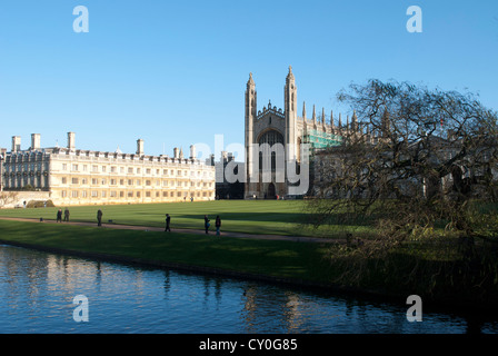 Old Court of Clare College and Kings College Chapel next to the Cam with people walking on the bank Stock Photo