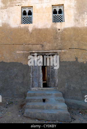 Old House In Arabic Style With Wooden Windows And Door, Mirbat, Oman Stock Photo