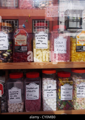 Jars of sweets in a shop window. Stock Photo