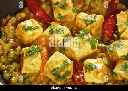 Mattar Paneer  is a north Indian dish consisting of Paneer,the Indian cottage cheese and peas in a slightly sweet  spicy sauce. Stock Photo