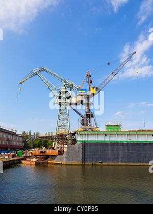 Big cranes and dock at the shipyard in Gdansk, Poland. Stock Photo