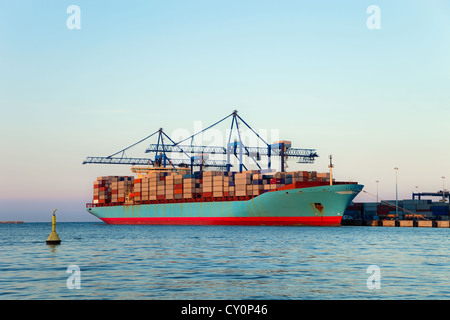 Container Ship during loading at port of Gdansk, Poland. Stock Photo