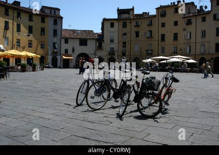 Tourist bicycles for hire in the piazza, in the picturesque village of Lucca, Tuscany, Italy. Stock Photo