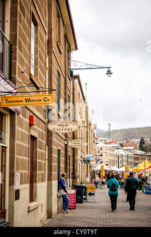 People near shops & restaurants in historical sandstone buildings at Salamanca Place in Hobart, Tasmania, Australia Stock Photo