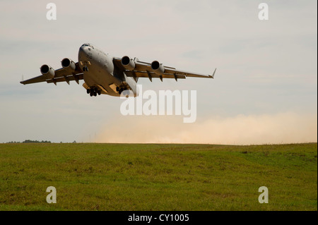 A U.S. Air Force C-17 Globemaster III aircraft takes off from Geronimo landing zone during a field exercise at the Joint Readiness Training Center (JRTC), Fort Polk, La., Oct. 15, 2012. JRTC 13-01 is designed to prepare and educate U.S. military Service members for deployments to the Middle East. Stock Photo