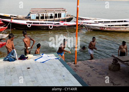 Young Men jumping into the River Ganges in Varanasi, India Stock Photo