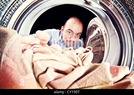 portrait of man view from washing machine inside Stock Photo