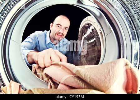 portrait of man view from washing machine inside Stock Photo