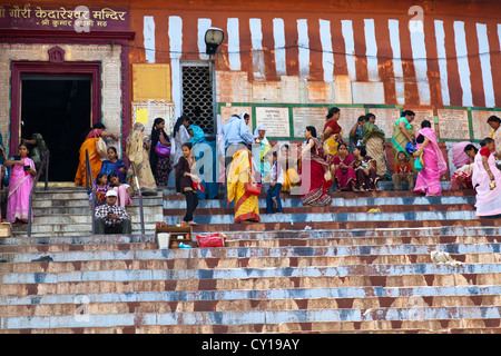 People hanging around on the Stairs of the Ghats on the Banks of the River Ganges in Varanasi, India Stock Photo