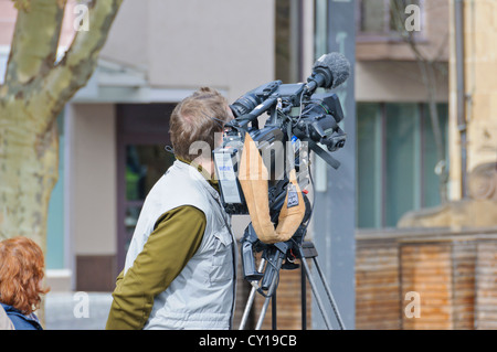 TV cameraman with digital TV camera on a tripod from the German public television station broadcaster WDR Stock Photo