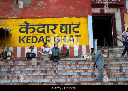 People hanging around on the Stairs of the Ghats on the Banks of the River Ganges in Varanasi, India Stock Photo
