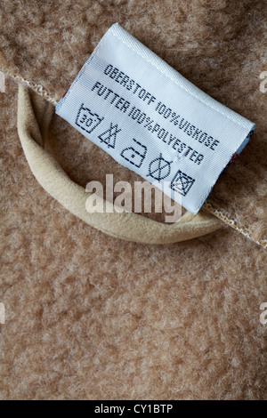 100% viskose 100% polyester label in coat - care washing symbols and instructions Stock Photo