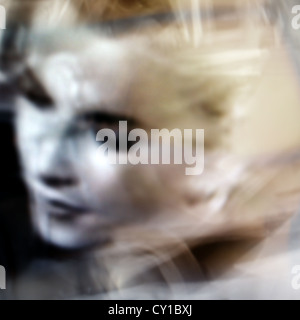blurred dream image of a young woman looking down Stock Photo