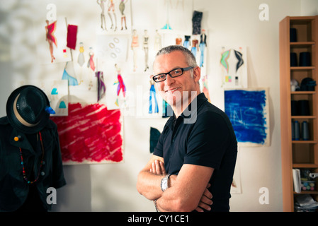 Confident entrepreneur, portrait of happy mature man working as fashion designer and dressmaker in atelier Stock Photo