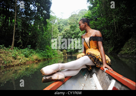 A ballerina posing on a wooden canoe in the Chagres River. Stock Photo