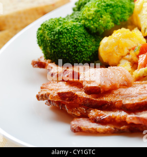 Omelet with vegetables, fried bacon and bread Stock Photo