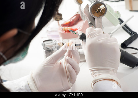 Dental technician working with articulator in dental laboratory  Stock Photo