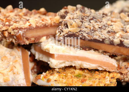 Different types of English Toffee with a variety of chocolates and nuts with a shallow depth of field. Stock Photo