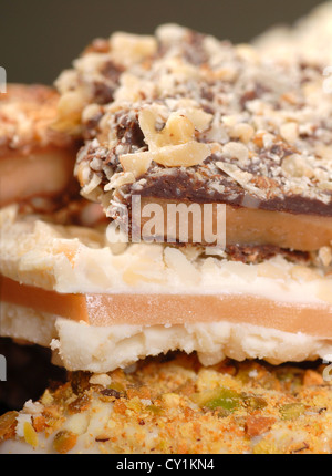 Different types of English Toffee with a variety of chocolates and nuts with a shallow depth of field. Stock Photo