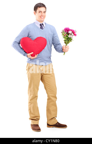 Full length portrait of a young man holding flowers and red heart isolated on white background Stock Photo