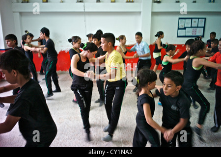 Young dancers practice the salsa on the academy's dance floor. Stock Photo