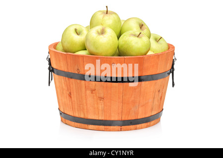 Studio shot of green apples in a wooden barrel isolated on white background Stock Photo