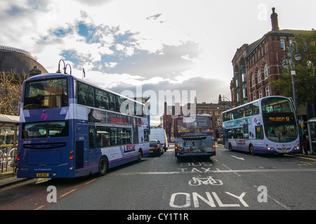 three buses abreast ahead of road markings re buses & taxis Stock Photo