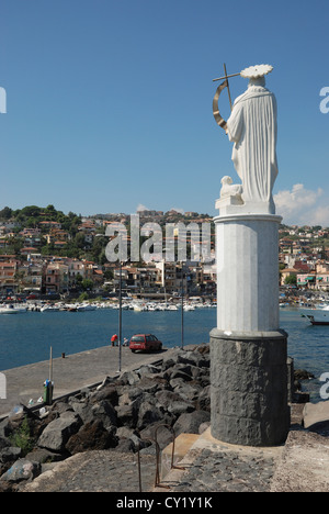 A statue overlooking the harbour at Aci Trezza, Sicily, Italy. Stock Photo