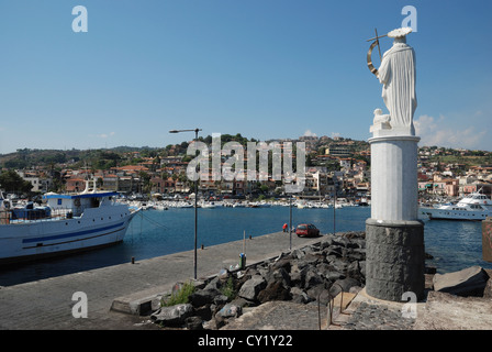 A statue overlooking the harbour at Aci Trezza, Sicily, Italy. Stock Photo