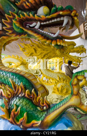 An artist spraypaints an ornamental dragon in Ubud, Bali, Indonesia